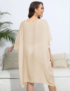 Detail view of the lightweight beige crochet beach cover-up with textured fabric