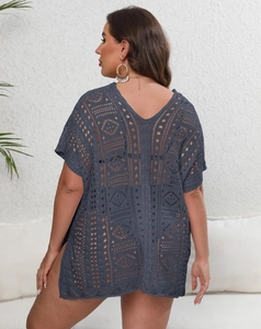 Detail of dark gray crochet beach cover-up showing hollow-out texture and V-neckline