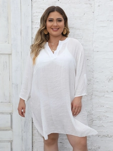 Detail of white V-neck cover-up dress showing breathable textured fabric and loose sleeves