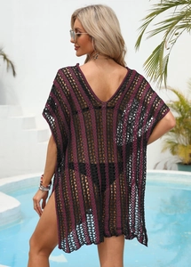Close-up of knit hollow-out beach cover-up with purple and black striped texture