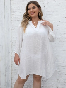Detail of white V-neck cotton linen beach cover-up showing light textured fabric