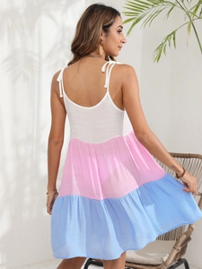 Detail view of adjustable bow shoulder straps on a striped tricolor beach sundress