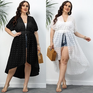 Detail of polka dot chiffon cover-up showing waist drawstring and high-low hem in black and white