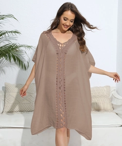 Detail of the brown V-neck crochet stitching and loose bohemian beach cover-up fabric