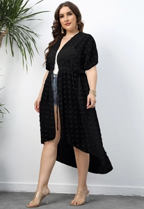 Detailed texture of black polka dot chiffon beach cover-up with tie-waist and V-neckline