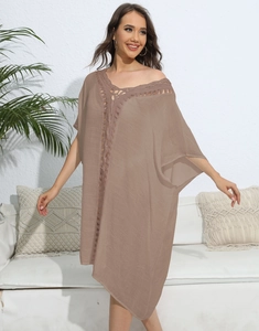 Detail of crochet embroidery lace on a loose brown boho beach cover-up dress for women