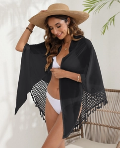 Detail of black chiffon beach wrap skirt featuring crochet mesh and elegant fringe tassels
