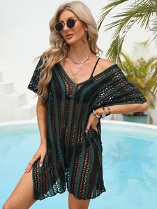Detail of crochet knit beach cover-up featuring green and black stripes and V-neck