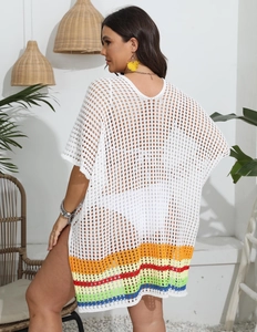 Detail of crochet beach cover-up with rainbow stripe hem and white hollow knit pattern