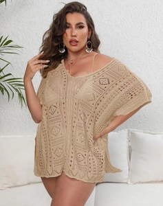 Detail of crochet beach cover up showing intricate hollow out geometric knit patterns