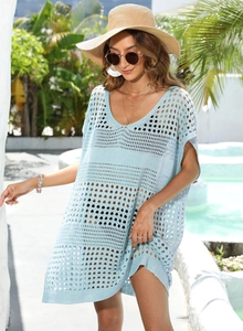Detail of light blue knit hollow-out beach cover-up with V-neck and crochet pattern