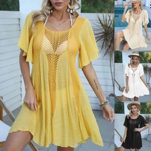 Detail of bohemian crochet beach cover-up showing intricate knit patterns in four colors