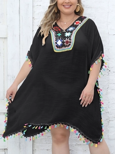 Detail of V-neck crochet embroidery and colorful tassels on black beach cover-up