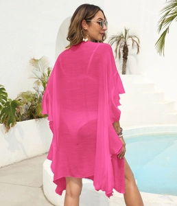 Detail of ruffle trim on magenta sheer chiffon beach cover-up with a flowy aesthetic