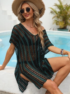 Detailed knit texture of a black and green striped V-neck crochet beach cover-up
