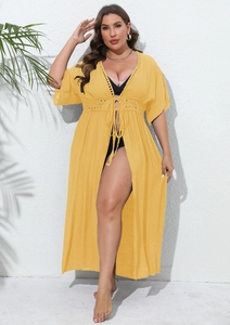 Detailed view of yellow lace trim beach cover-up with drawstring and cutout patterns