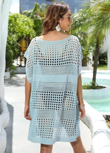 Close-up of light blue crochet beach cover-up with hollow knit pattern and mesh texture