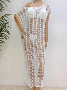 Macro detail of the white crochet beach cover-up showing vertical hollow knit mesh texture