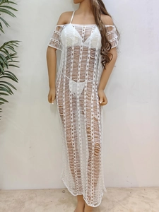 Close-up of white crochet beach cover-up featuring vertical hollow-out knit patterns