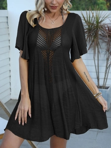 Detailed view of black crochet beach cover-up with intricate hollow-out knit patterns