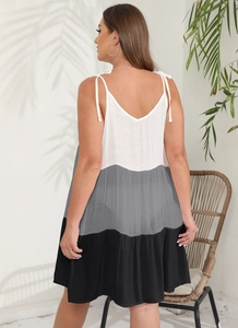 Detail of adjustable tie-up shoulder straps on a color-block A-line summer sundress