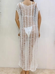 Detailed back view of a white long crochet beach cover-up with hollow knit patterns