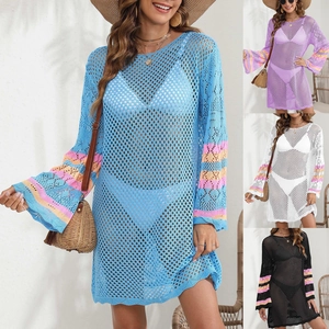 Detail of crochet beach cover-up featuring flared sleeves with colorful stripe accents