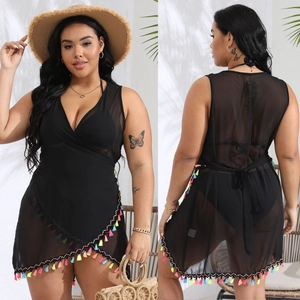 Detail of black mesh beach cover-up featuring colorful fringe trim and wrap design