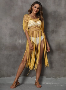Detail of yellow hollow-out crochet beach dress featuring honeycomb mesh and long tassels