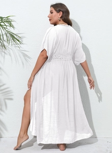 Detail of white plus size beach cover-up featuring lace patchwork and side slit