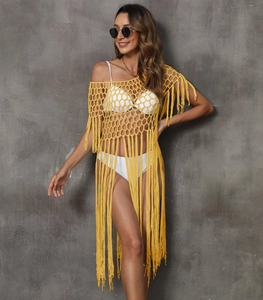Detailed view of yellow crochet beach cover-up featuring hollow mesh and long tassels
