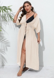 Close-up of beige plus size beach cover-up featuring intricate crochet lace and tie-front