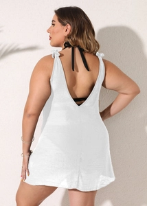 Detailed back view of white beach cover-up featuring elegant bow knots and open back design