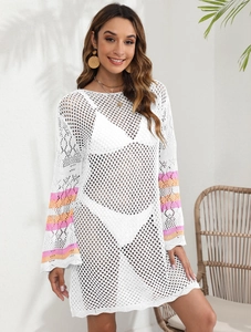 Detail of white crochet beach cover-up with orange and pink striped flared sleeves