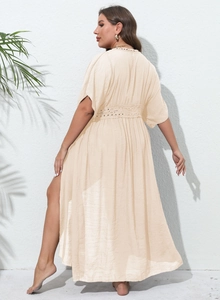 Detail of beige lace crochet trim and high side slit on beach cover-up maxi dress