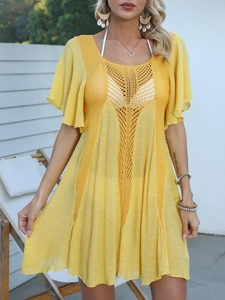 Close-up of ginger yellow beach cover-up featuring intricate crochet hollow-out lace details