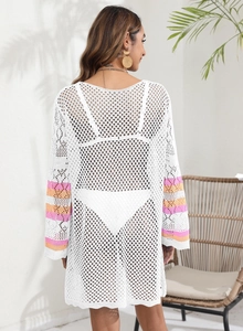 Detail of white crochet beach cover-up with orange and pink striped sleeve accents
