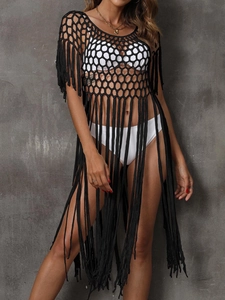 Close-up of black crochet beach cover-up with hollow mesh and long tassel fringe