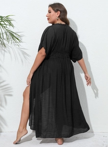 Detail of black beach cover-up featuring intricate crochet waist and side split design