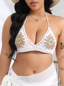 Detail of handmade crochet bikini top featuring large sunflower appliques and scalloped edges