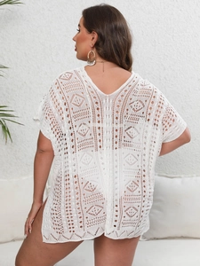 Detailed back view of white crochet beach cover-up with intricate hollow-out knit patterns