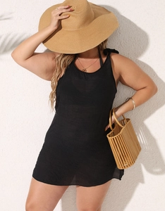 Detail of a plus size black sleeveless beach cover-up with lightweight fabric and tassels