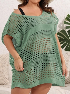 Detailed knit texture of green crochet beach cover-up with openwork geometric patterns