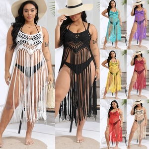 Detail showing various colors of plus size crochet beach cover up with fringe tassels