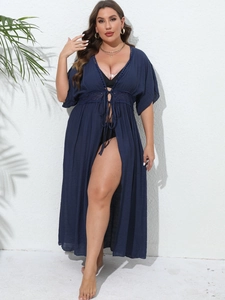 Detailed view of dark blue beach cover-up featuring intricate crochet lace and drawstring waist