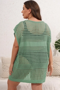 Detail of green crochet hollow knit fabric texture on a sleeveless beach cover-up dress