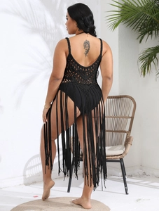 Detail of black crochet beach cover-up with deep V-back design and long tassel hemline