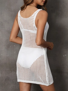 Macro detail of white crochet beach cover-up showing mesh texture and knit pattern
