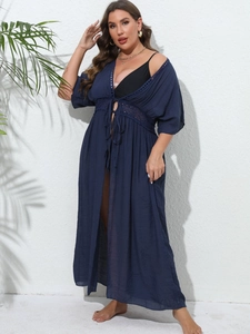 Detail of navy lace hollow-out embroidery on a long bohemian beach cover-up cardigan