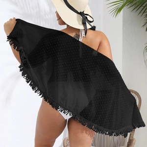 Detail of black chiffon beach cover-up featuring fringe hem and polka dot texture
